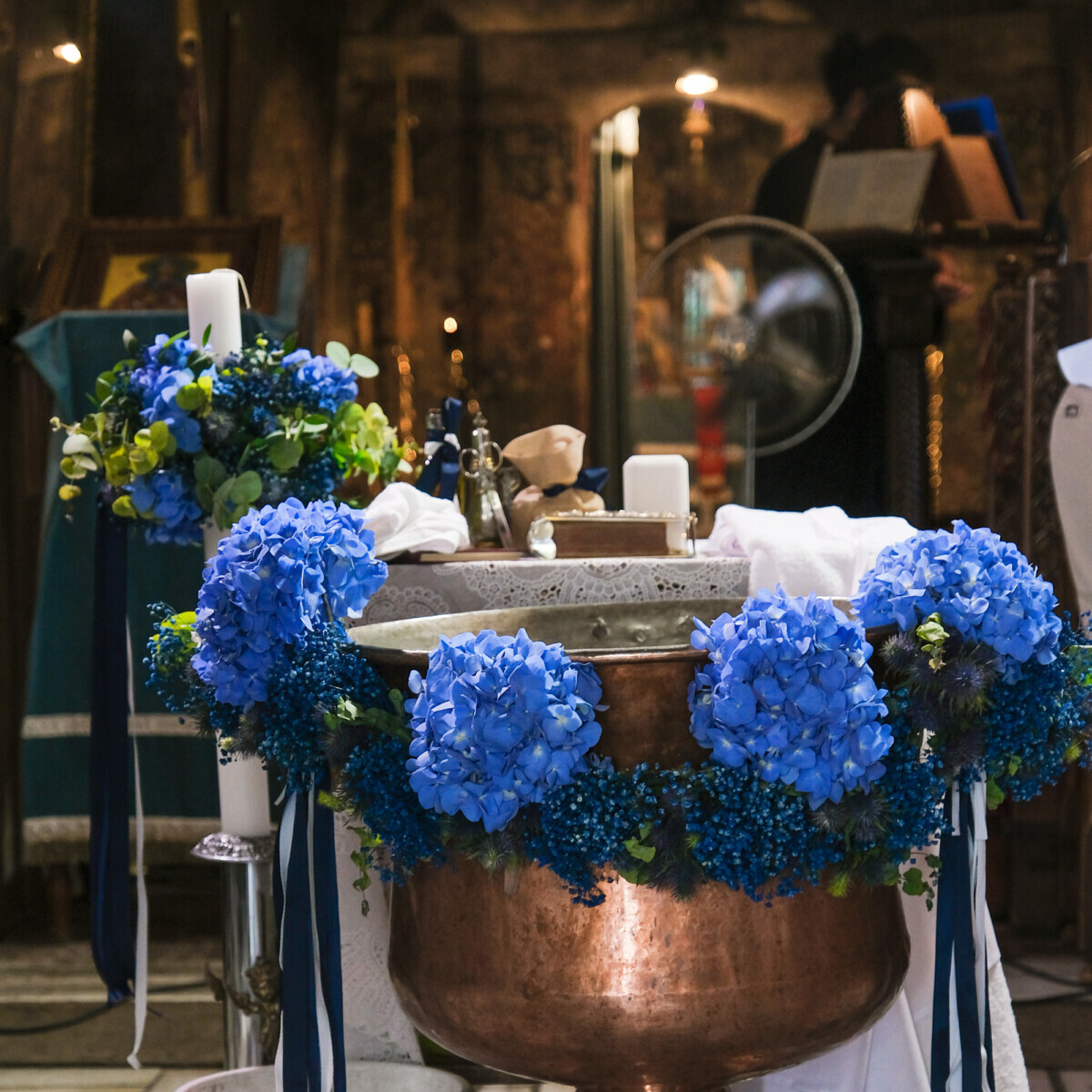 Baptistery Decoration for a Baptism in Greece for a boy with garland of blue hydrangeas and blue gypsophila.